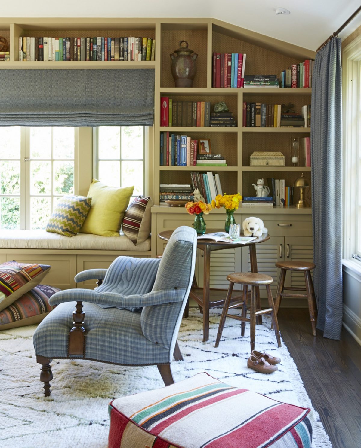 A child-friendly family room provides closed storage perfect for stashing toys and a low-slung table with stools small enough for a child but stylish enough to please the grown-ups. (Victoria Pearson/Nathan Turner via AP)