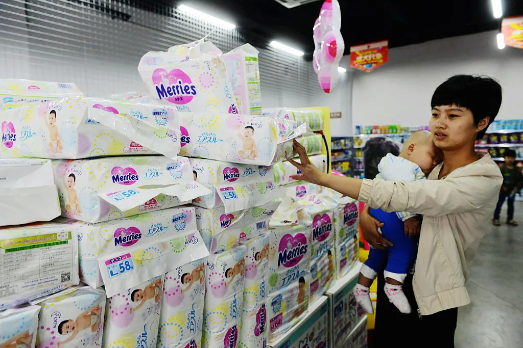 A customer chooses diapers from a supermarket that sells imported products in Qingdao, Shandong Province on June 8, 2015. (STR/AFP/Getty Images)