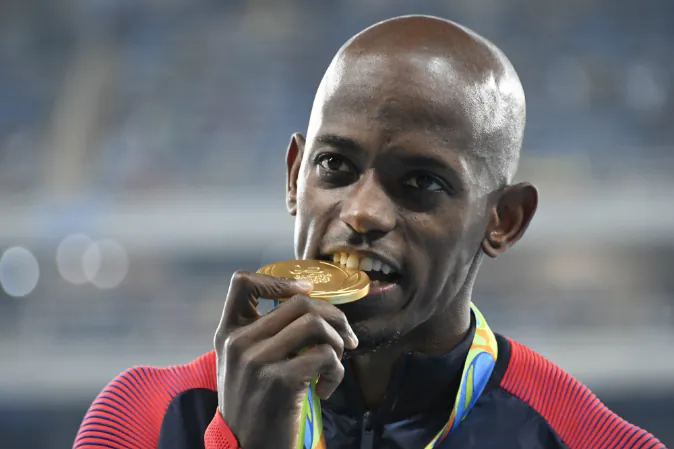 USA's Jeff Henderson bites the gold medal during the podium ceremony for the Men's Long Jump at the athletics event at the Rio 2016 Olympic Games at the Olympic Stadium in Rio de Janeiro on August 14, 2016. (DAMIEN MEYER/AFP/Getty Images)