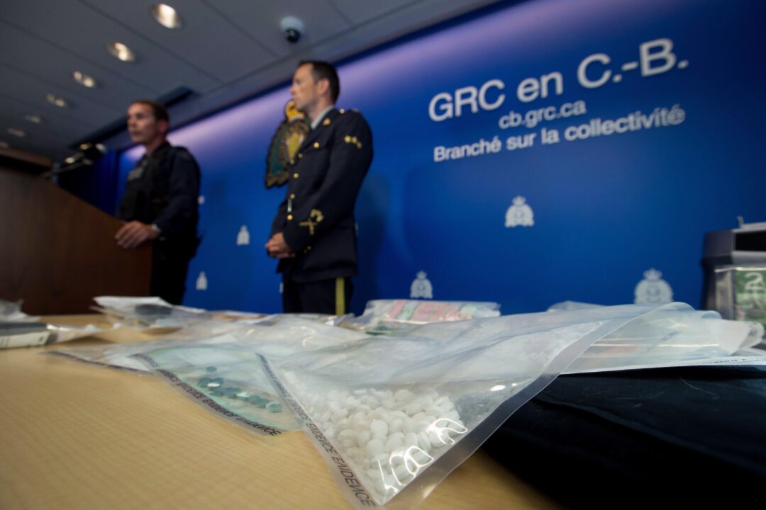 Fake oxycontin pills containing fentanyl are displayed during a news conference at RCMP headquarters in Surrey, B.C., on Sept. 3, 2015. (Darryl Dyck/The Canadian Press)