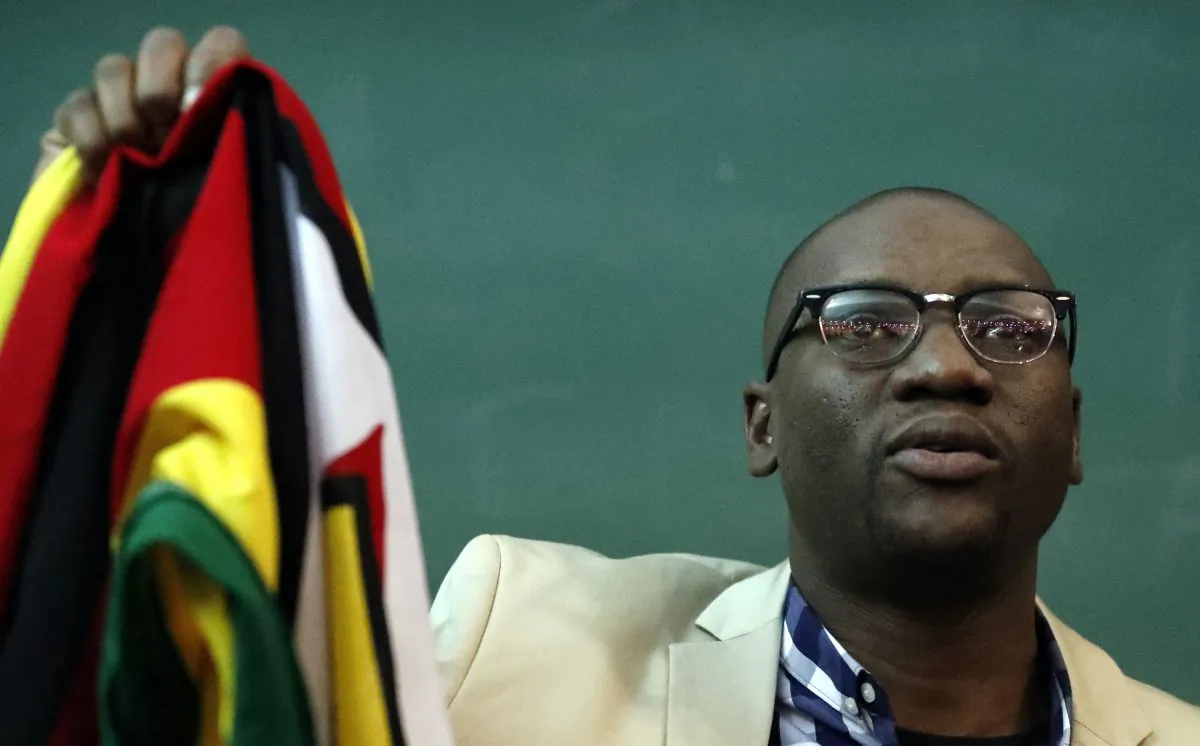 Zimbabwean pastor Evan Mawarire holds his country's flag before addressing supporters at the University of the Witwatersrand in Johannesburg, South Africa, on July 28, 2016. (AP Photo/Themba Hadebe)