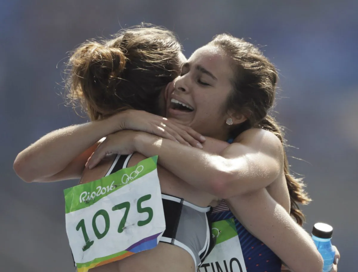 New Zealand's Nikki Hamblin, left, and United States' Abbey D'Agostino after competing in a women's 5000-meter heat during the athletics competitions of the 2016 Summer Olympics at the Olympic stadium in Rio de Janeiro, Brazil on Aug. 16, 2016. (AP Photo/David J. Phillip)