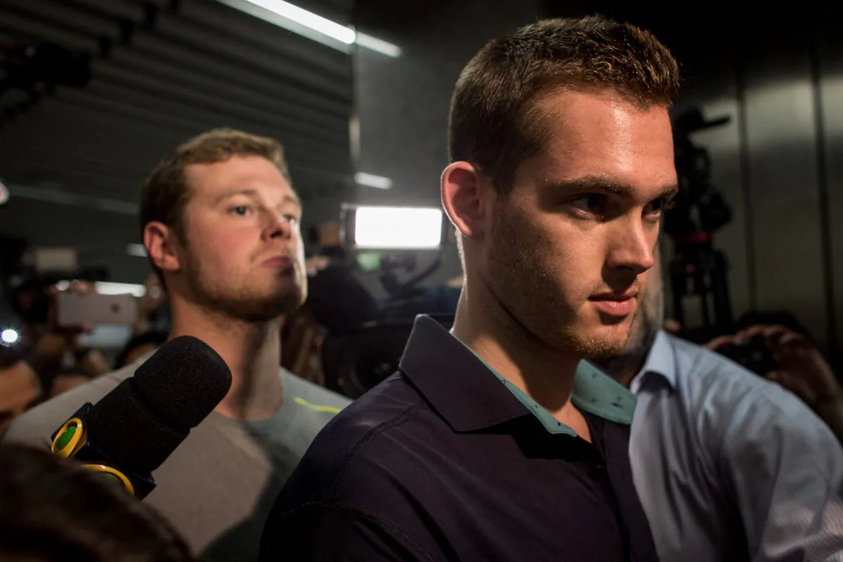 U.S Olympic swimmers Gunnar Bentz and Jack Conger leave the police headquarters at International departures of Rio de Janiero's Galeo International airport on August 18, 2016 in Rio de Janiero, Brazil. (Photo by Chris McGrath/Getty Images)