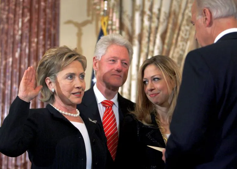 In this Feb. 2, 2009 file photo, Vice President Joe Biden, right, swears in Secretary of State Hillary Rodham Clinton in a ceremonial swearing-in at the State Department in Washington, accompanied by her husband, former President Bill Clinton, and their daughter, Chelsea. This time, it's Bill Clinton's turn to be the adoring spouse, rapt and smiling when the cameras cut away from the candidate in the spotlight. He’ll be the He in the VIP box watching as a She accepts the presidential nomination at the Democratic convention on Thursday, July 28, 2016. It's one small step in the role reversal that Americans will need to get used to if Hillary Clinton wins in November. (AP Photo/Lawrence Jackson, File)