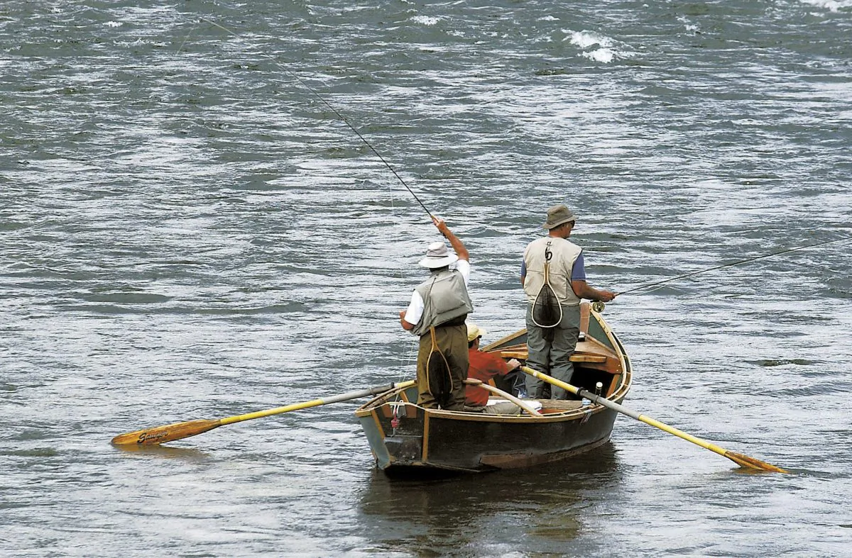 Two fly fishermen and an oarsman test their angling skills as they float down the Yellowstone River near Pine Creek, Mont., fishing access on Sept. 9, 2004. Montana is closing a 175-mile stretch of the Yellowstone River to all recreational activities to prevent the spread of a parasite that is believed to have killed tens of thousands of fish, authorities said Friday., Aug. 19, 2016. (Garrett Cheen/The Livingston Enterprise via AP)