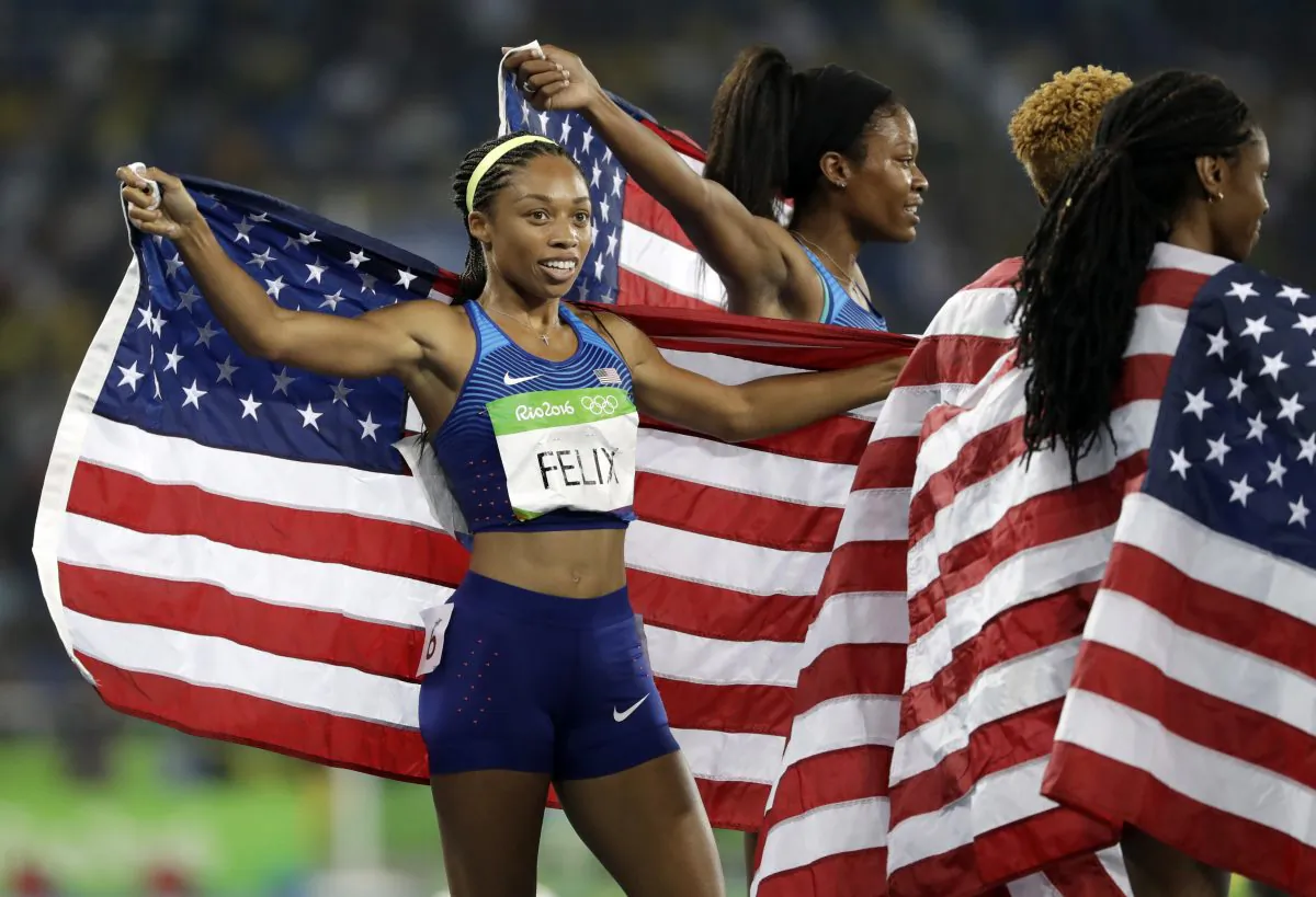 USA' Allyson Felix celebrates with her teammates after winning the gold medal in the women's 4x400-meter relay final during the athletics competitions of the 2016 Summer Olympics at the Olympic stadium in Rio de Janeiro, Brazil, on Aug. 20, 2016. (AP Photo/David J. Phillip)