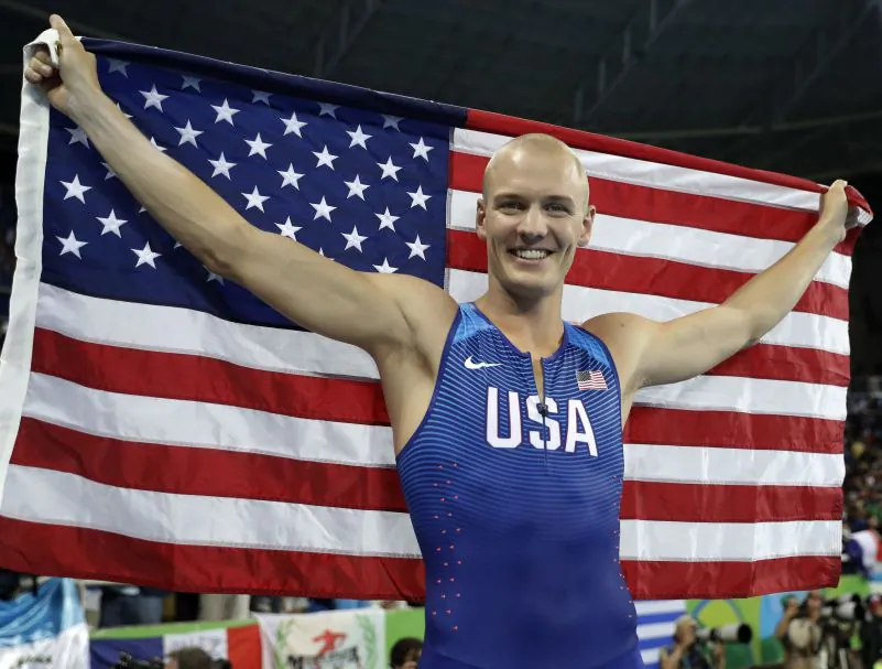 United States' Sam Kendricks poses with the U.S. flag after winning the bronze medal in the men's pole vault final during the athletics competitions of the 2016 Summer Olympics at the Olympic stadium in Rio de Janeiro, Brazil, Tuesday, Aug. 16, 2016. (AP Photo/Matt Dunham)