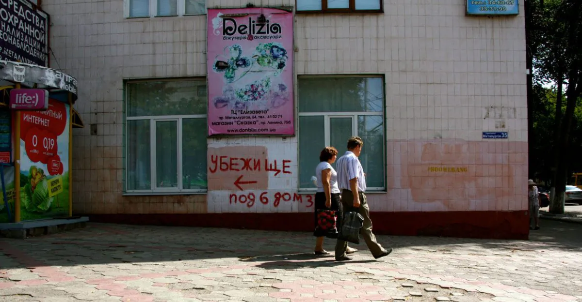 Spray-painted signs pointing to the nearest bomb shelter, like this one in Mariupol, are common sights in cities across Ukraine. (Nolan Peterson/The Daily Signal)