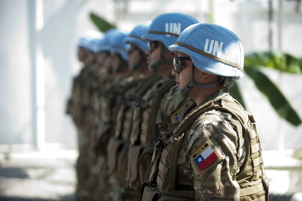 Chile's Army, part of the U.N. Stabilization Mission in Haiti (MINUSTAH) give honors to Cristian Barros, U.N. Security Council (UNSC) president, during the visit of the representatives of 15 Member States of the UNSC to the facilities of the Cuartel Carrera of Batallion Chile, in Cap-Haitien, on Jan. 24, 2015. (Hector Retamal/AFP/Getty Images)
