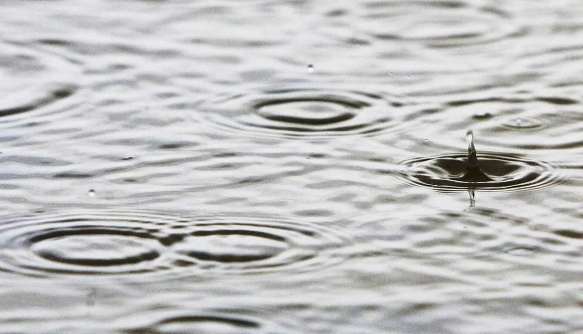 Rain falls forming puddles on the Birdsville Track, near Marree, Australia, on June 9, 2005. (Ian Waldie/Getty Images)