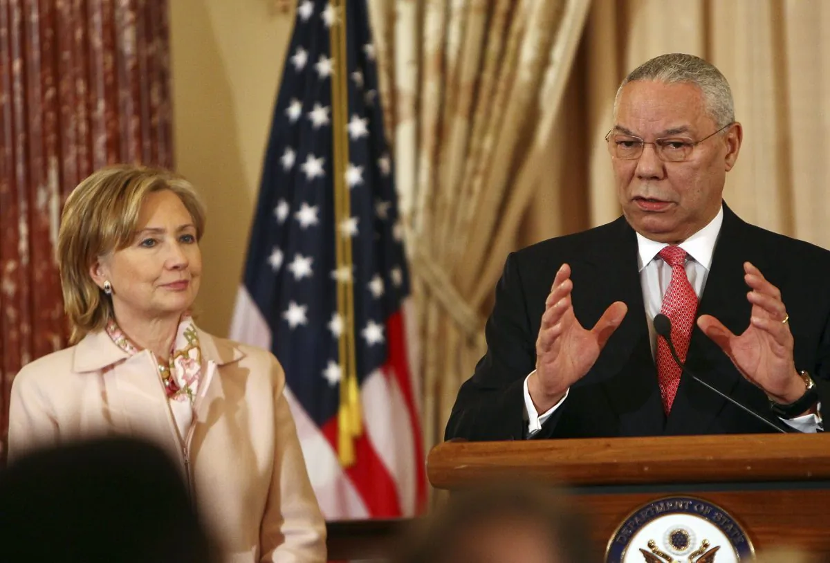 Former U.S. Secretary of State Colin Powell (R) speaks with U.S. Secretary of State Hillary Clinton during an unveiling ceremony for his official State Department portrait in the Benjamin Franklin Room at the State Department Dec. 7, 2009 in Washington, DC. (Win McNamee/Getty Images)