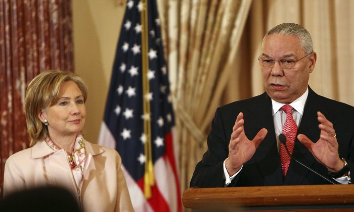 Former U.S. Secretary of State Colin Powell (R) speaks with U.S. Secretary of State Hillary Clinton during an unveiling ceremony for his official State Department portrait in the Benjamin Franklin Room at the State Department Dec. 7, 2009 in Washington, DC. (Win McNamee/Getty Images)