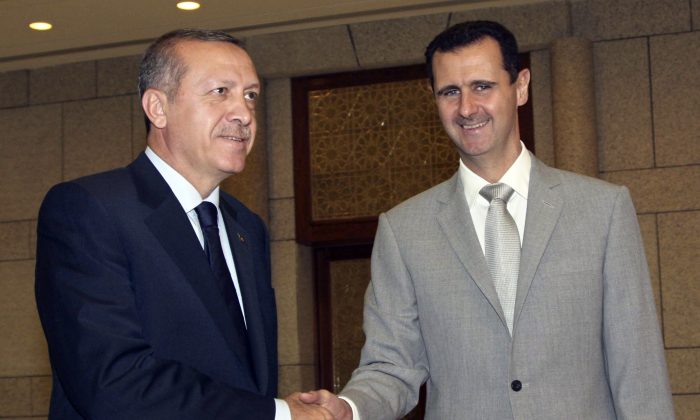 Syrian President Bashar Assad (R) shakes hands with then Turkish Prime Minister Recep Tayyip Erdogan, at Al-Shaab presidential palace in Damascus, Syria, on Oct. 11, 2010. (Bassem Tellawi/AP Photo)