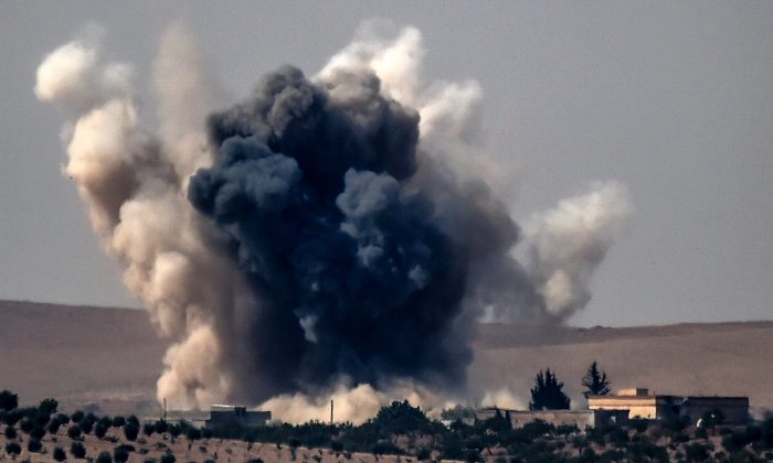 Stock photo of smoke billows following air strikes. (Bulent Kilic/AFP/Getty Images)