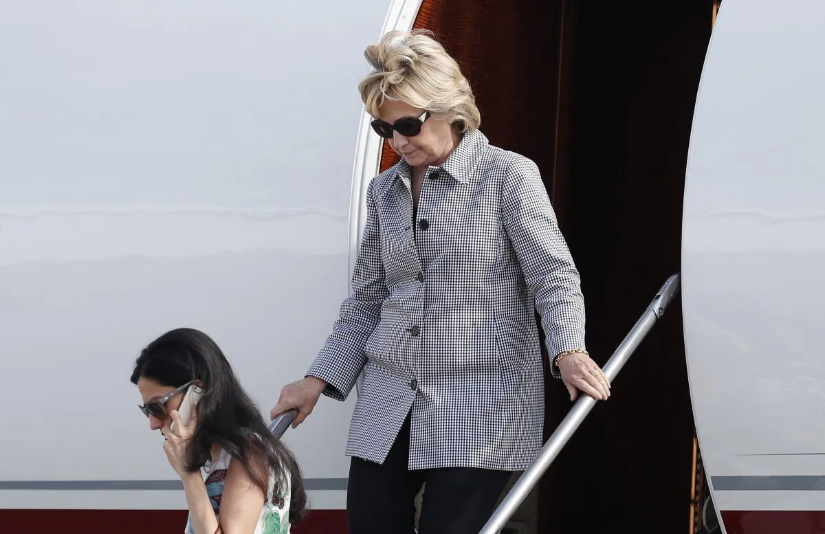 Democratic presidential nominee Hillary Clinton and aide Huma Abedin, lower left, step from Clinton's campaign plane as they arrive at Van Nuys Airport in Van Nuys, Calif. on Aug. 22, en route to a taping of "Jimmy Kimmel Live!" in Los Angeles. (AP Photo/Carolyn Kaster)