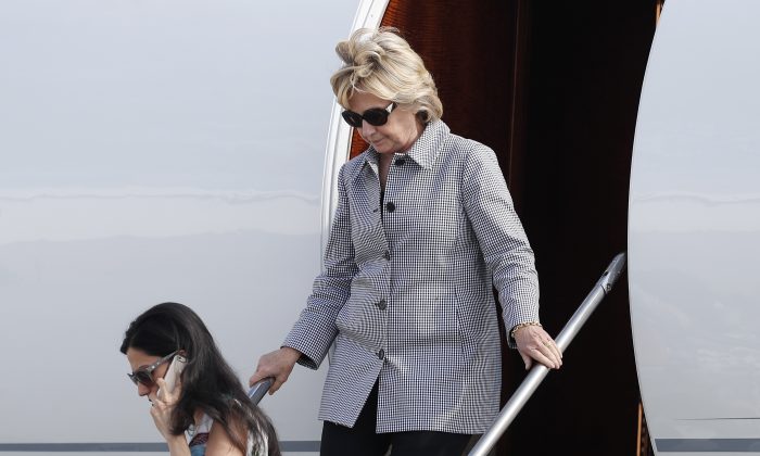 Democratic presidential nominee Hillary Clinton and aide Huma Abedin, lower left, step from Clinton's campaign plane as they arrive at Van Nuys Airport in Van Nuys, Calif. on Aug. 22, en route to a taping of "Jimmy Kimmel Live!" in Los Angeles. (AP Photo/Carolyn Kaster)