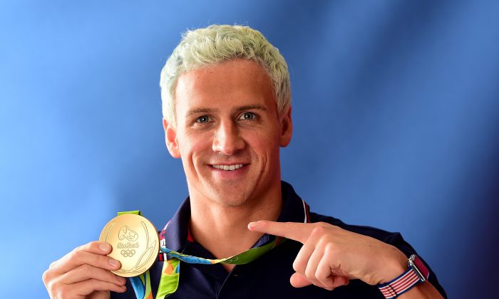 Swimmer, Ryan Lochte of the United States poses for a photo with his gold medal on the Today show set on Copacabana Beach in Rio de Janeiro, Brazil on Aug. 12, 2016. (Harry How/Getty Images)