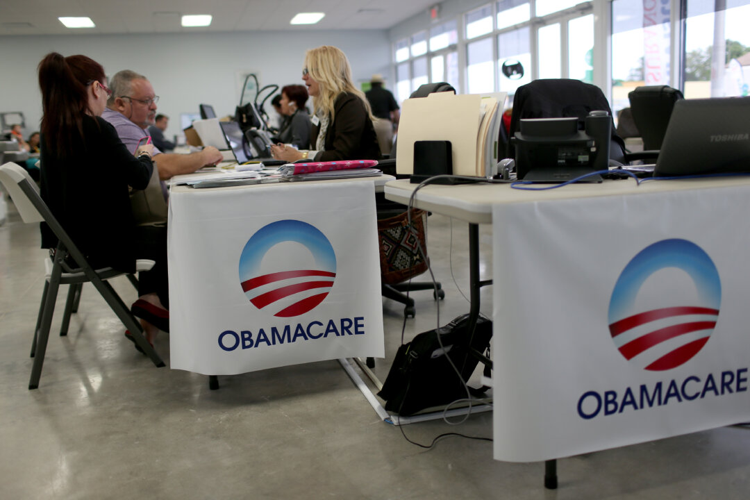 MIAMI, FL - FEBRUARY 05:  Aymara Marchante (L) and Wiktor Garcia sit with Maria Elena Santa Coloma, an insurance advisor with UniVista Insurance company, as they sign up for the Affordable Care Act, also known as Obamacare, before the February 15th deadline on February 5, 2015 in Miami, Florida. Numbers released by the government show that the Miami-Fort Lauderdale-West Palm Beach metropolitan area has signed up 637,514 consumers so far since open enrollment began on Nov. 15, which is more than twice as many as the next large metropolitan area, Atlanta, Georgia.  (Photo by Joe Raedle/Getty Images)