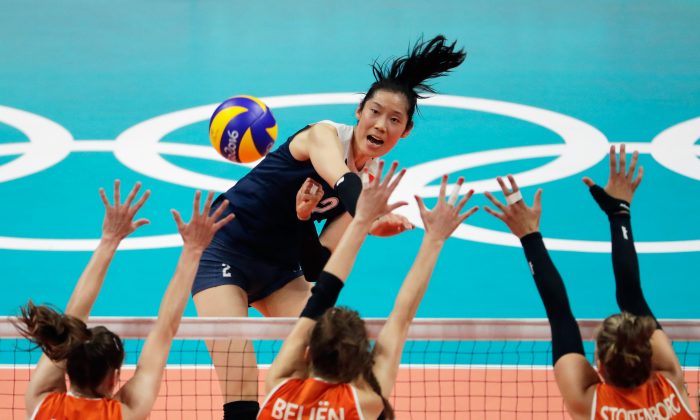 Chinese volleyball player Zhu Ting strikes the ball at the Netherlands defence during the Women's Volleyball Semifinal match at the Maracanazinho at Rio Olympic Games in Rio de Janeiro, Brazil, on August 18, 2016. (Jamie Squire/Getty Images)