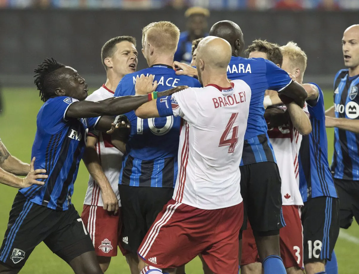 Toronto FC and Montreal Impact players push and shove in the first half at BMO Field in Toronto on Aug. 27, 2016. Montreal’s Callum Mallace was sent off for his actions that led to the skirmish. (The Canadian Press/Fred Thornhill)