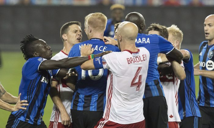 Toronto FC and Montreal Impact players push and shove in the first half at BMO Field in Toronto on Aug. 27, 2016. Montreal’s Callum Mallace was sent off for his actions that led to the skirmish. (The Canadian Press/Fred Thornhill)
