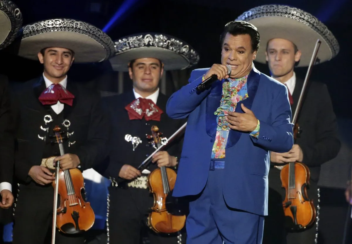 FILE - In this April 28, 2016, file photo, Mexican singer Juan Gabriel performs during the Latin Billboard Awards in Coral Gables, Fla. Representatives of Juan Gabriel have reported Sunday, Aug. 28, 2016, that he has died. Gabriel was Mexico's leading singer-songwriter and top-selling artist with sales of more than 100 million albums. The statement says he died Sunday, but did not say where. (AP Photo/Wilfredo Lee, File)