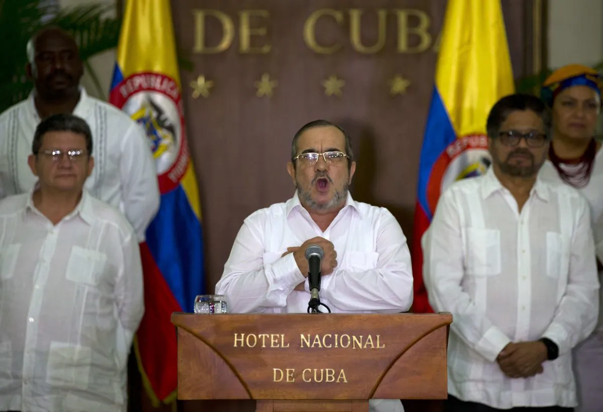 Commander of the Revolutionary Armed Forces of Colombia or FARC, Rodrigo Londono, better known as Timochenko or Timoleon Jimenez talks to the press, accompanied by Ivan Marquez, right, chief negotiator of the Revolutionary Armed Forces of Colombia and Pablo Catatumbo, left, chief of the FARC's western bloc, in Havana, Cuba, August 28, 2016. (AP Photo/Ramon Espinosa)
