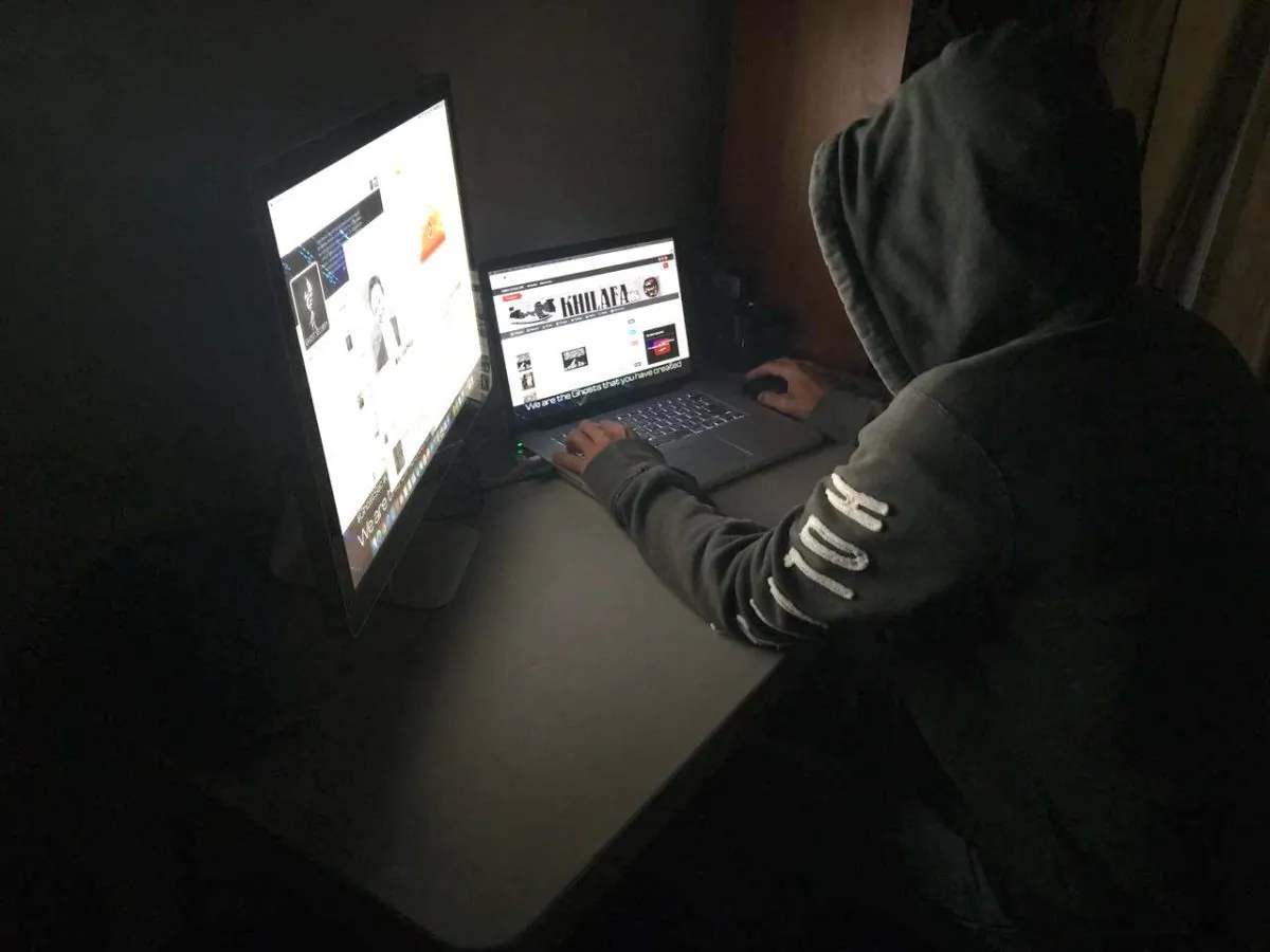 Ani-terrorist hacker with Anonymous, WauchulaGhost, works on a laptop. (Courtesy of WauchulaGhost)