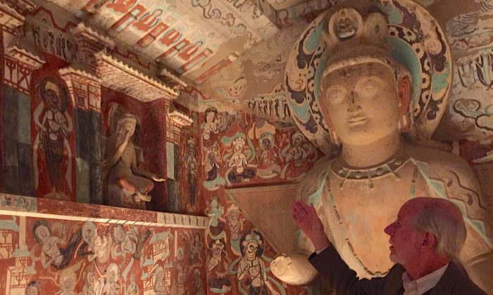 Neville Agnew, a senior principal project specialist at the Getty Conservation Institute, describes the meaning of wall paintings in a replica of a cave from Dunhuang, China at the Getty Center museum in Los Angeles, Calif. on June 1, 2016. (Sarah Le/Epoch Times)