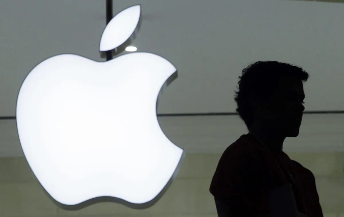 In this file photo, a person stands near the Apple logo at the company's Grand Central Terminal store in New York on Dec. 7, 2011. (AP Photo/Mark Lennihan, File)