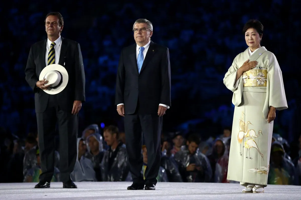 Rio de Janeiro Mayor Eduardo Paes, IOC President Thomas Bach and Tokyo Governor Yuriko Koike take part in the Flag Handover Ceremony during the Closing Ceremony on Day 16 of the Rio 2016 Olympic Games at Maracana Stadium in Rio de Janeiro, Brazil, on Aug. 21, 2016. (Cameron Spencer/Getty Images)