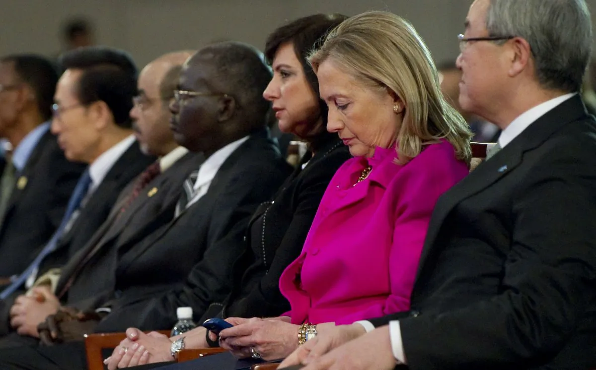 Then Secretary of State Hillary Clinton checks her BlackBerry while attending a forum in Busan, South Korea, on Nov. 30, 2011. (Saul Loeb/AFP/Getty Images)
