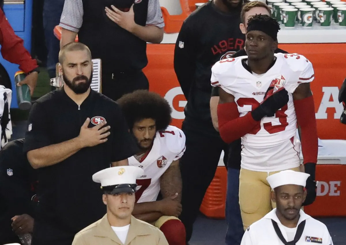 San Francisco 49ers quarterback Colin Kaepernick (C) kneels during the national anthem before the team's NFL preseason football game against the San Diego Chargers, in San Diego, on Sept. 1, 2016. (AP Photo/Chris Carlson)