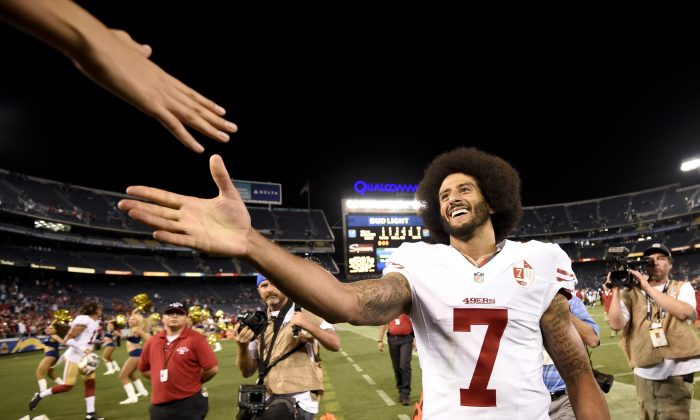 San Francisco 49ers quarterback Colin Kaepernick shakes hands with fans after the 49ers defeated the San Diego Chargers 31-21 during an NFL preseason football game in San Diego on Sept. 1, 2016. Kaepernick's jersey is the league's top seller. (AP Photo/Denis Poroy)