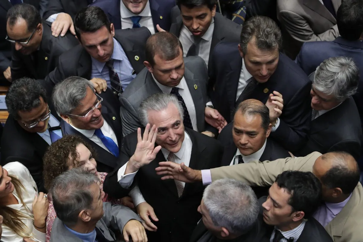 Brazil's President Michel Temer (C) is surrounded by senators as he arrives to take the presidential oath at the National Congress, in Brasilia, Brazil, on Aug. 31, 2016. (AP Photo/Eraldo Peres)