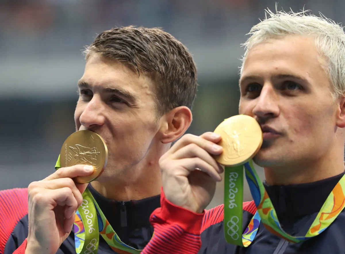 USA' Michael Phelps (L) and Ryan Lochte celebrate winning the gold medal in the men's 4x200-meter freestyle relay during the swimming competitions at the 2016 Summer Olympics in Rio de Janeiro, Brazil, on Aug. 10, 2016. (AP Photo/Lee Jin-man)