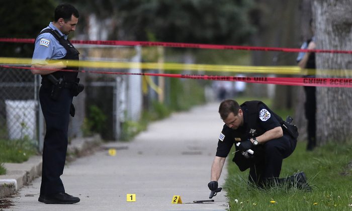 Police investigate a shooting in Chicago, Ill., in a file photograph. (Joshua Lott/Getty Images)