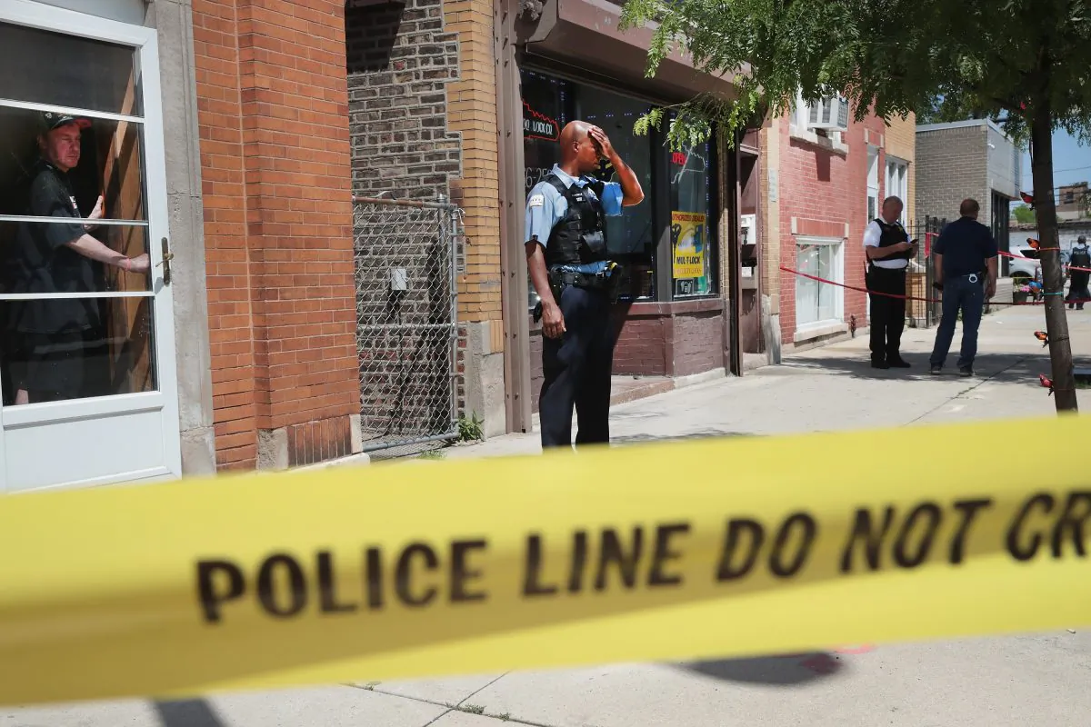 Police investigate a crime scene after two people were shot in Chicago on June 15. (Scott Olson/Getty Images)
