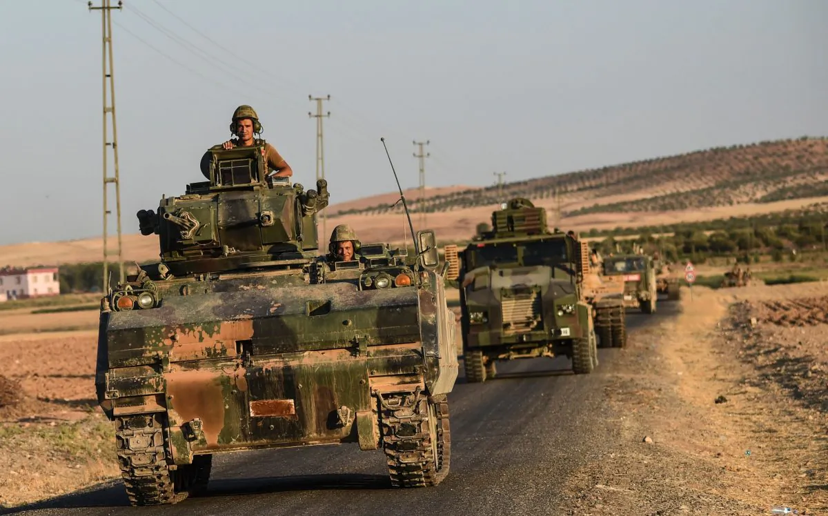 Turkish soldiers stand in a Turkish Army tank driving back to Turkey from the Syrian-Turkish border town of Jarabulus, in the Turkish-Syrian border town of Karkamis, on Sept. 2, 2016. (Bulent Kilic/AFP/Getty Images)