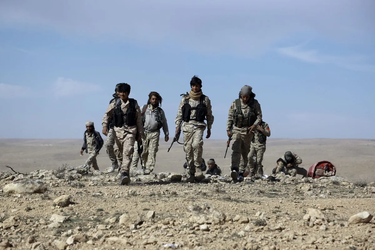 Fighters from the Syrian Democratic Forces (SDF), an alliance dominated by the Kurdish People's Protection Units (YPG), gather on the outskirts of the town of al-Shadadi, in Hasakeh Province, northeastern Syria, on Feb. 19, 2016. (Delil Souleiman/AFP/Getty Images)