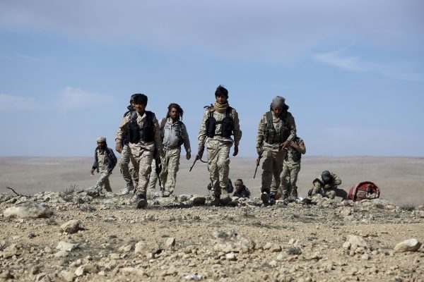 Fighters from the Syrian Democratic Forces (SDF), an alliance dominated by the Kurdish People's Protection Units (YPG), gather on the outskirts of the town of al-Shadadi, in Hasakeh Province, northeastern Syria, on Feb. 19, 2016. (Delil Souleiman/AFP/Getty Images)