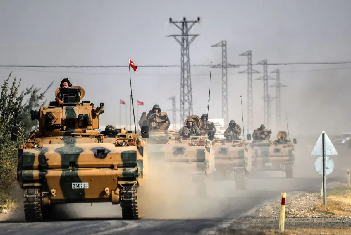 Turkish Army tanks drive to the Syrian-Turkish border town of Jarabulus on Aug. 25, 2016. (Bulent Kilic/AFP/Getty Images)