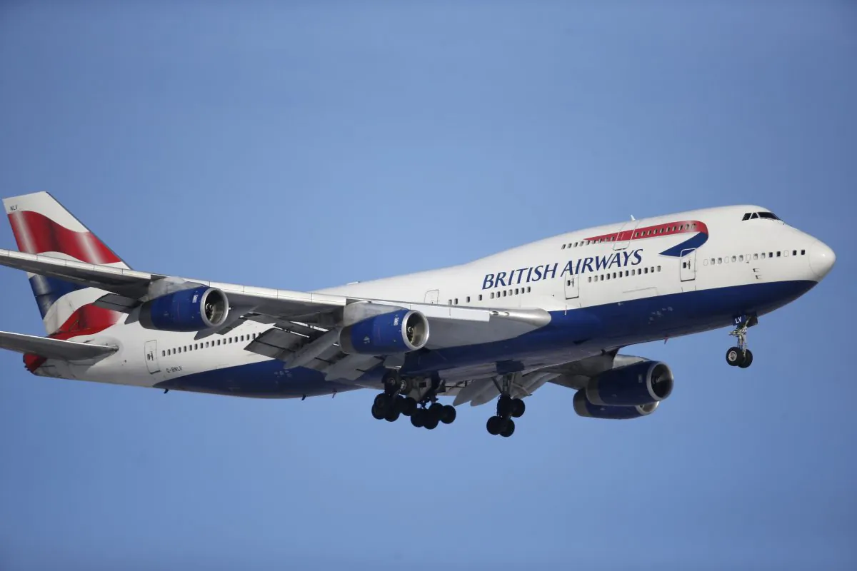 FILE -- In this Feb. 8, 2016 file photo, a British Airways plane lands on a runway at Denver International Airport. British Airways has apologized for delays caused by computer glitches in check-in systems — and warned that there may be further troubles. (AP Photo/David Zalubowski, File)