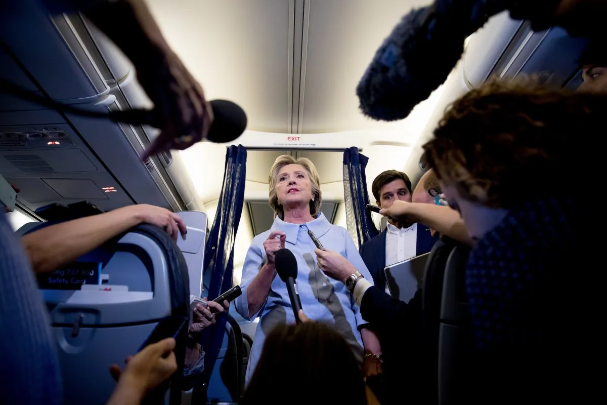 Democratic presidential candidate Hillary Clinton speaks to members of the media on her campaign plane while traveling to Quad Cities International Airport in Moline, Ill., Monday, Sept. 5, 2016. (AP Photo/Andrew Harnik)