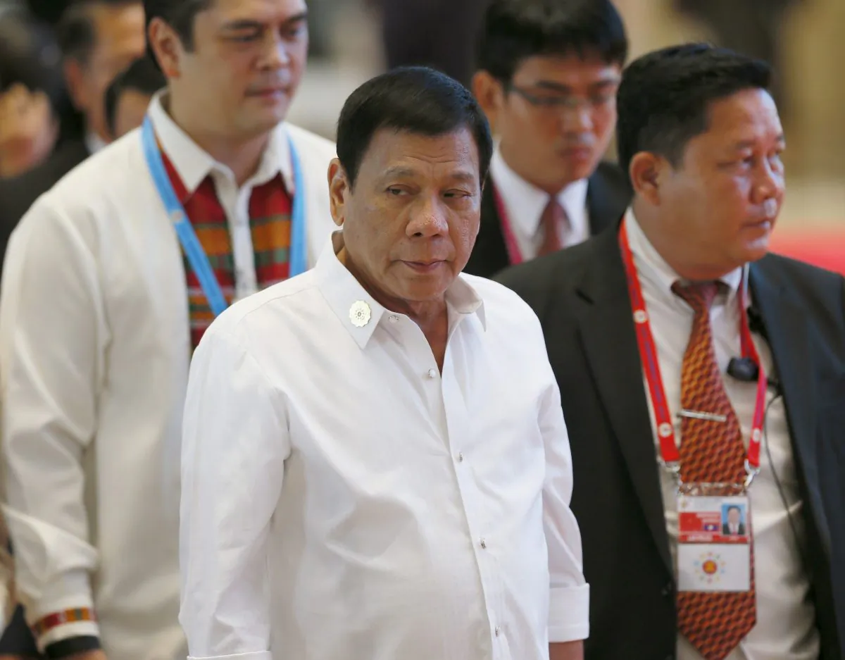 Philippine President Rodrigo Duterte, center, arrives at the National Convention Center for scheduled bilateral meetings with ASEAN leaders on the sidelines of the 28th and 29th ASEAN Summits and other related summits Tuesday, Sept. 6, 2016 in Vientiane, Laos. (AP Photo/Bullit Marquez)