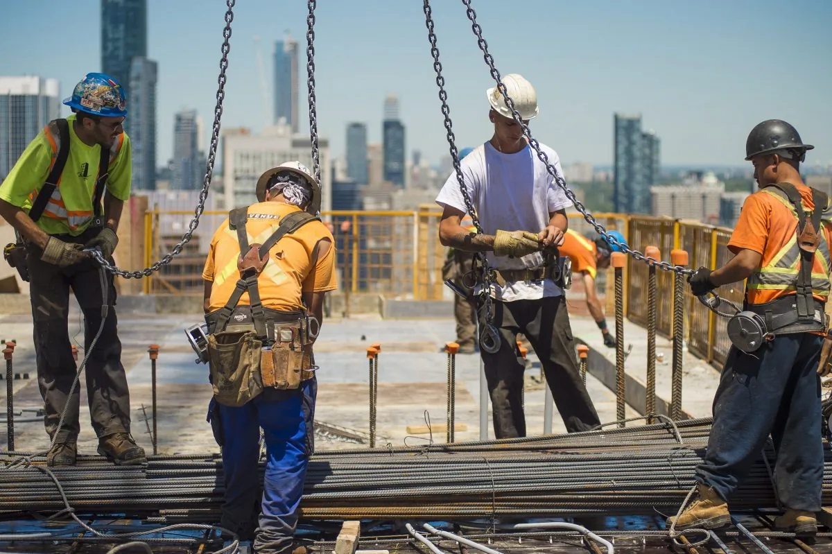Men work at a construction site in downtown Toronto on June 30, 2016. (The Canadian Press/Eduardo Lima)