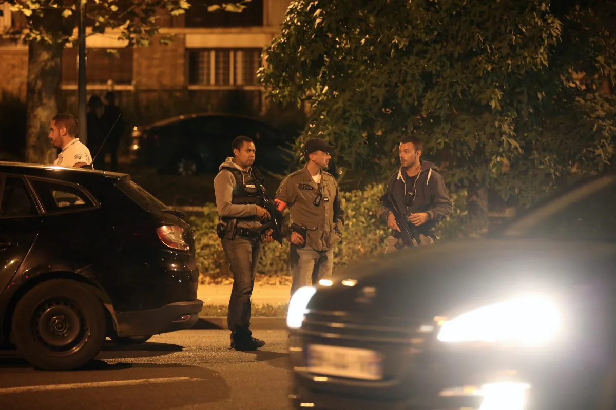 Police officers stand guard as they take part in a raid in Boussy-Saint-Antoine, east of Paris, Thursday, Sept. 8, 2016. French police detained three women planning 'imminent and violent action' after a standoff Thursday linked to a terrorism investigation into six gas canisters found in a car abandoned near Paris' Notre Dame Cathedral. (AP Photo/Thibault Camus)