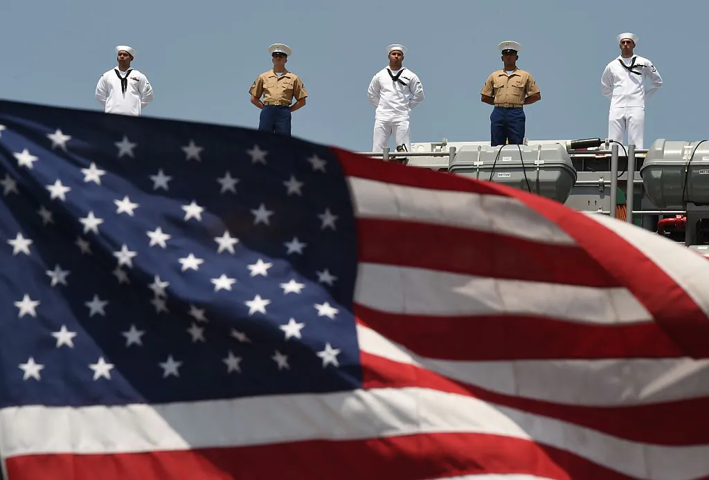 Sailors and Marines stand on the deck of the USS Bataan (LHD 5) as it arrives at Pier 88 during the 'Parade of Ships' ceremony to kick off Fleet Week in New York on May 25, 2016. (Timothy A. Clary/AFP/Getty Images)