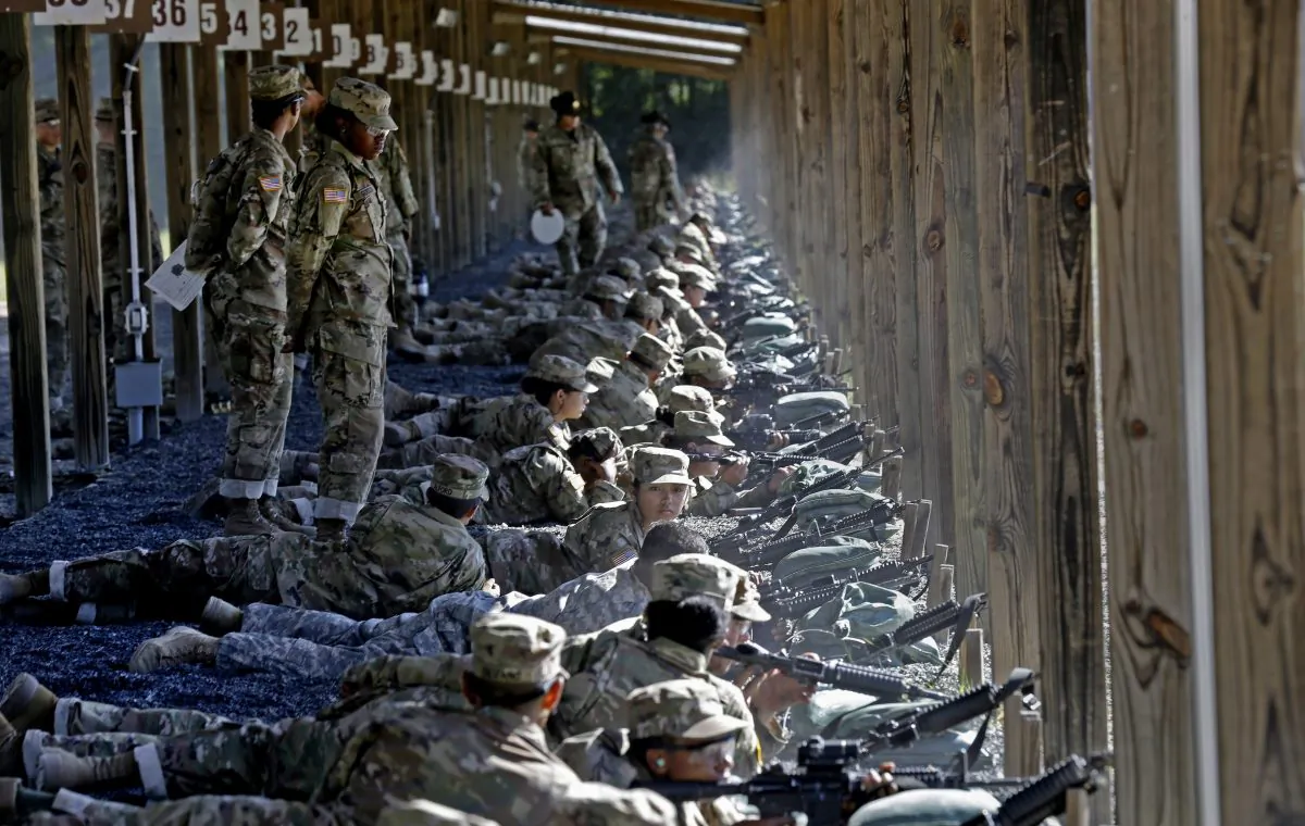 U.S. Army drill sergeants stand over recruits during a live-fire marksmanship training course at Fort Jackson, S.C., on Aug. 17, 2016. (AP Photo/Gerry Broome)