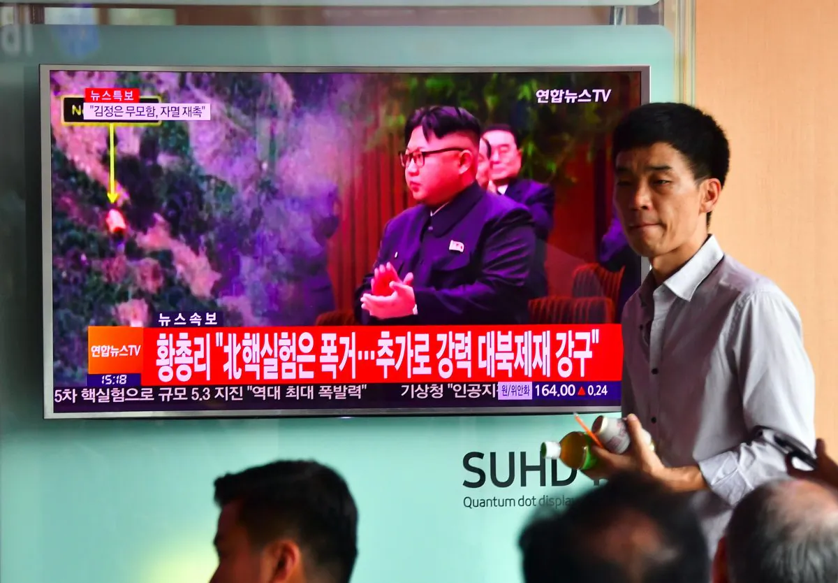 People watch a television news report, showing file footage of North Korean leader Kim Jong-un, at a railway station in Seoul on Sept. 9, 2016. (Jung Yeon-je/AFP/Getty Images)
